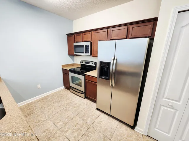 a kitchen with stainless steel appliances a refrigerator and a sink
