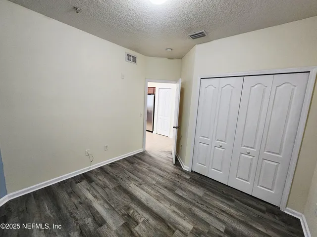 a view of a room with wooden floor