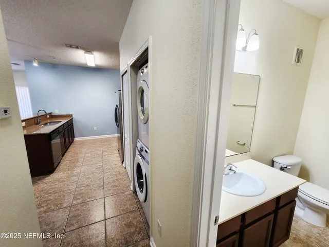 a bathroom with a sink and mirror with toilet