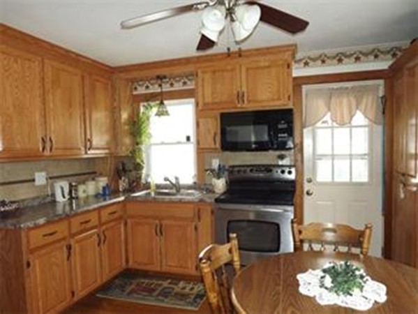 1 Robbins Road Monson, MA 01057 - Photo 2 of 3 a kitchen with a stove a sink and a microwave