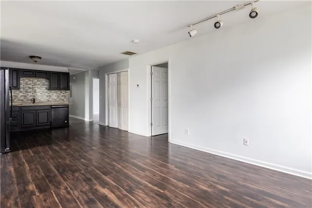 a view of kitchen and hall with wooden floor