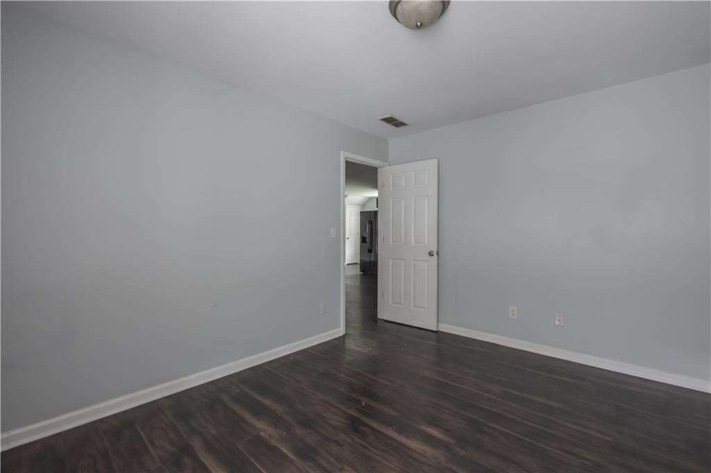1607 Ralph David Abernathy Boulevard Southwest Atlanta, GA 30310 - Photo 9 of 16 a view of an empty room with wooden floor