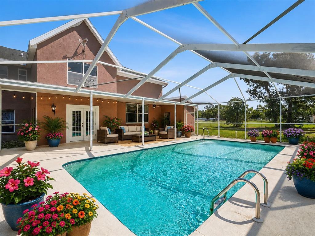 15420 Aubrey Avenue Spring Hill, FL 34610 - Photo 25 of 28 a view of a house with backyard sitting area and garden