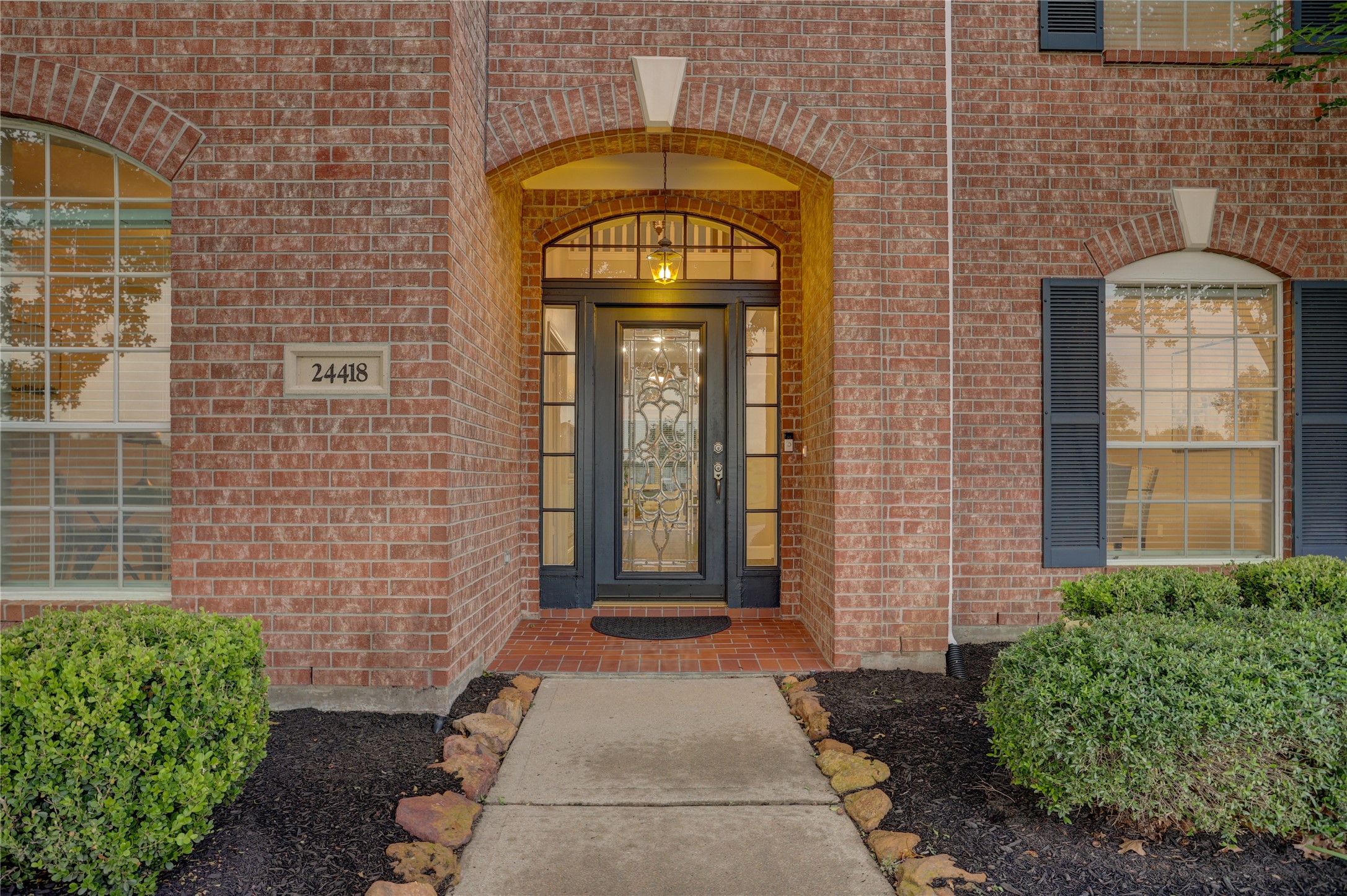 24418 Falcon Point Drive Katy, TX 77494 - Photo 2 of 40 A charming arched entryway welcomes you in, framed by classic architectural details and soft exterior lighting that creates a warm and inviting first impression.