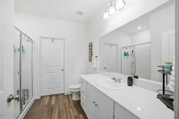 a spacious bathroom with a double vanity sink a mirror and a shower