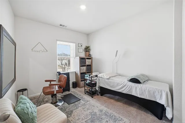 a bedroom with bed couch and window