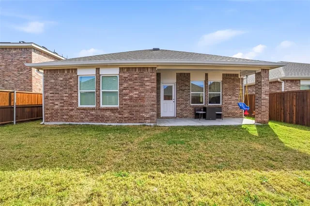 a view of a house with a backyard porch and furniture