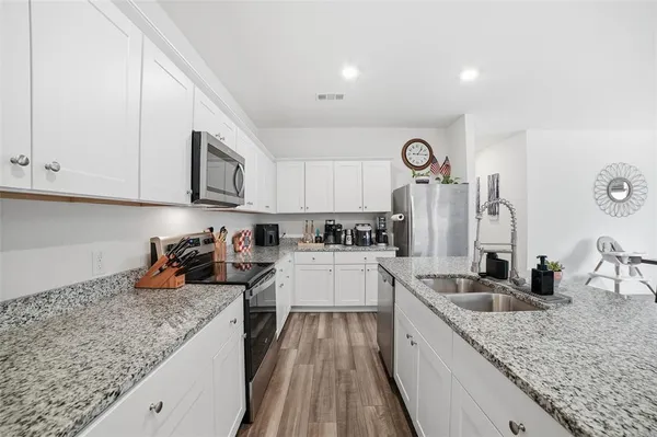 a kitchen with cabinets a sink and a stove