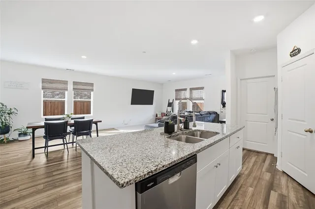 a kitchen with sink and view of living room