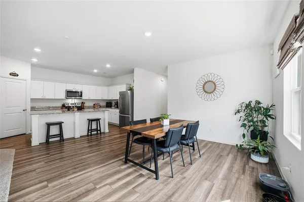 a view of a dining room with furniture and wooden floor