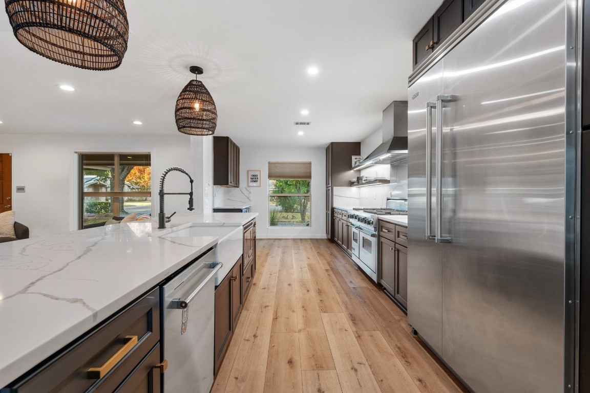 a kitchen with granite countertop a stove and a refrigerator