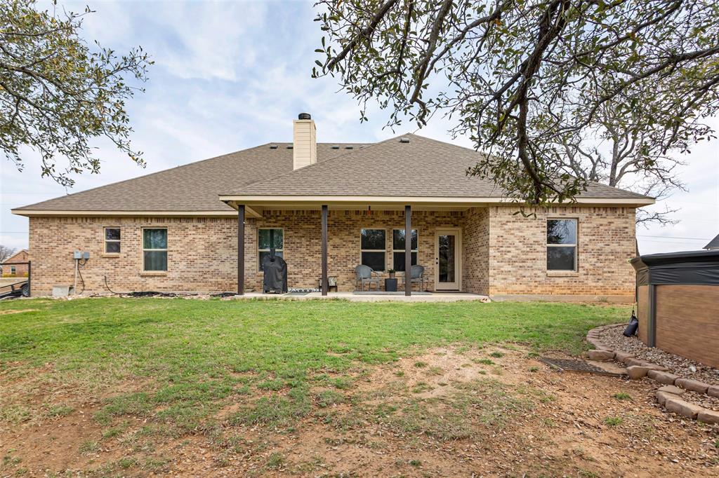 223 Cottongame Road Weatherford, TX 76088 - Photo 26 of 39 a front view of a house with a garden and porch