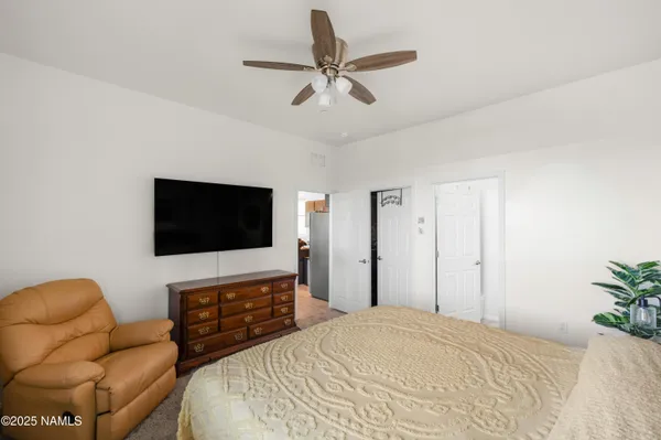 a bedroom with a bed and a flat screen tv