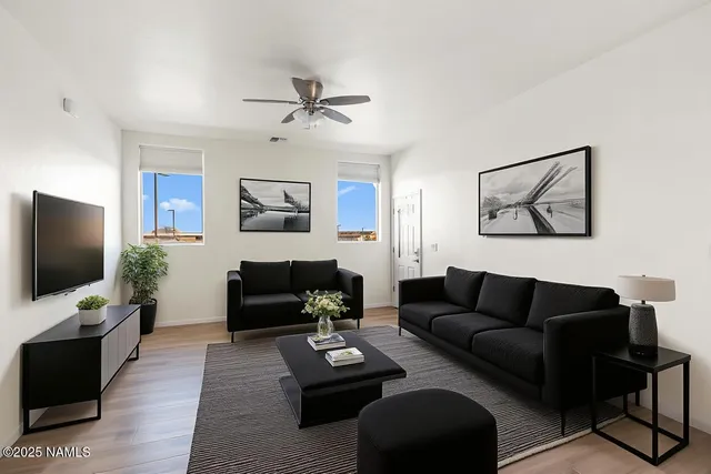 a living room with furniture and a flat screen tv