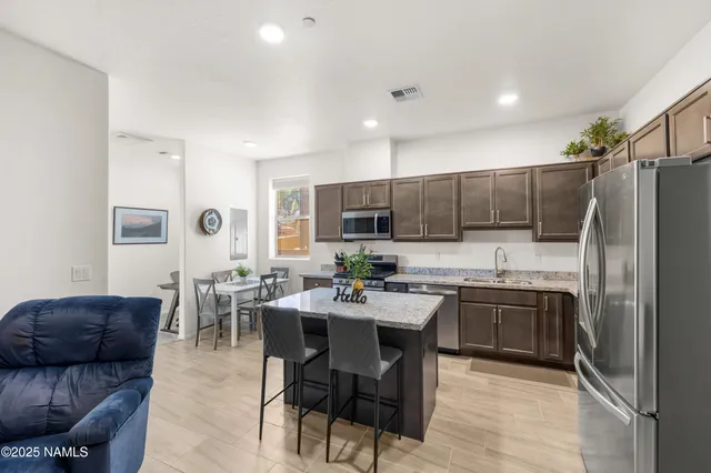 a kitchen with microwave a stove and furniture