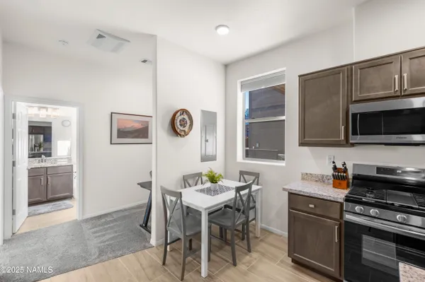 a kitchen with microwave a stove and furniture