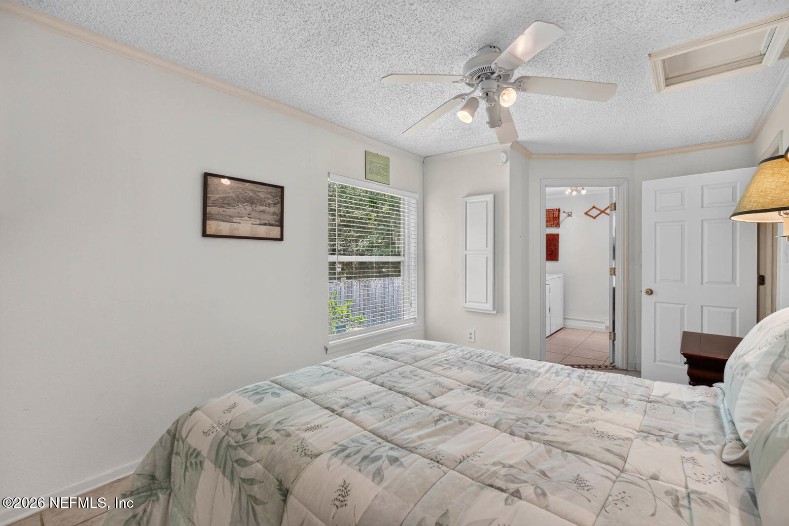 1950 Lightsey Road St. Augustine, FL 32084 - Photo 20 of 57 a bedroom with a bed and a chandelier