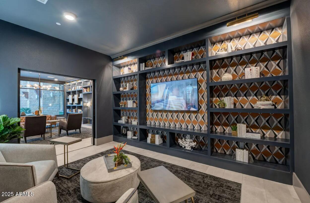 15501 North Dial Boulevard, Unit A1 Scottsdale, AZ 85260 - Photo 14 of 24 a living room with furniture a rug and a book shelf