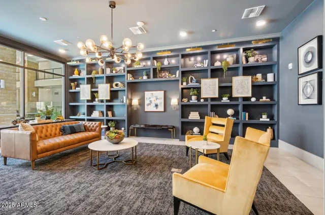 a living room with furniture a chandelier and a dining table