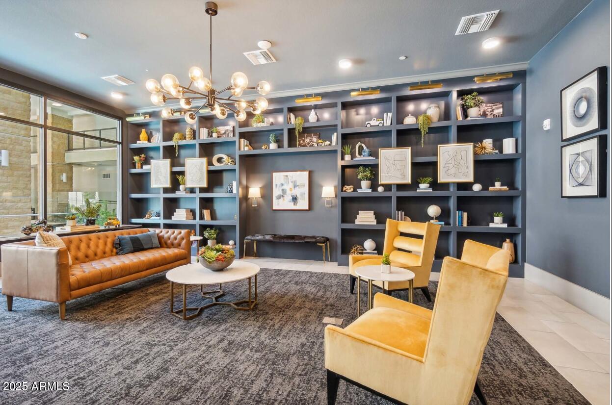 15501 North Dial Boulevard, Unit A1 Scottsdale, AZ 85260 - Photo 15 of 24 a living room with furniture a chandelier and a dining table