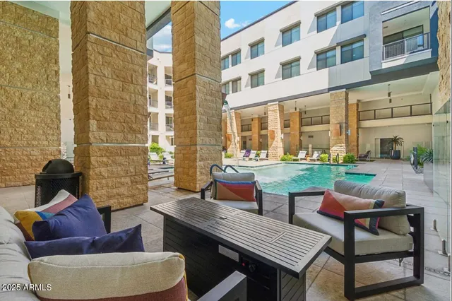 a view of a patio with couches table and chairs and potted plants