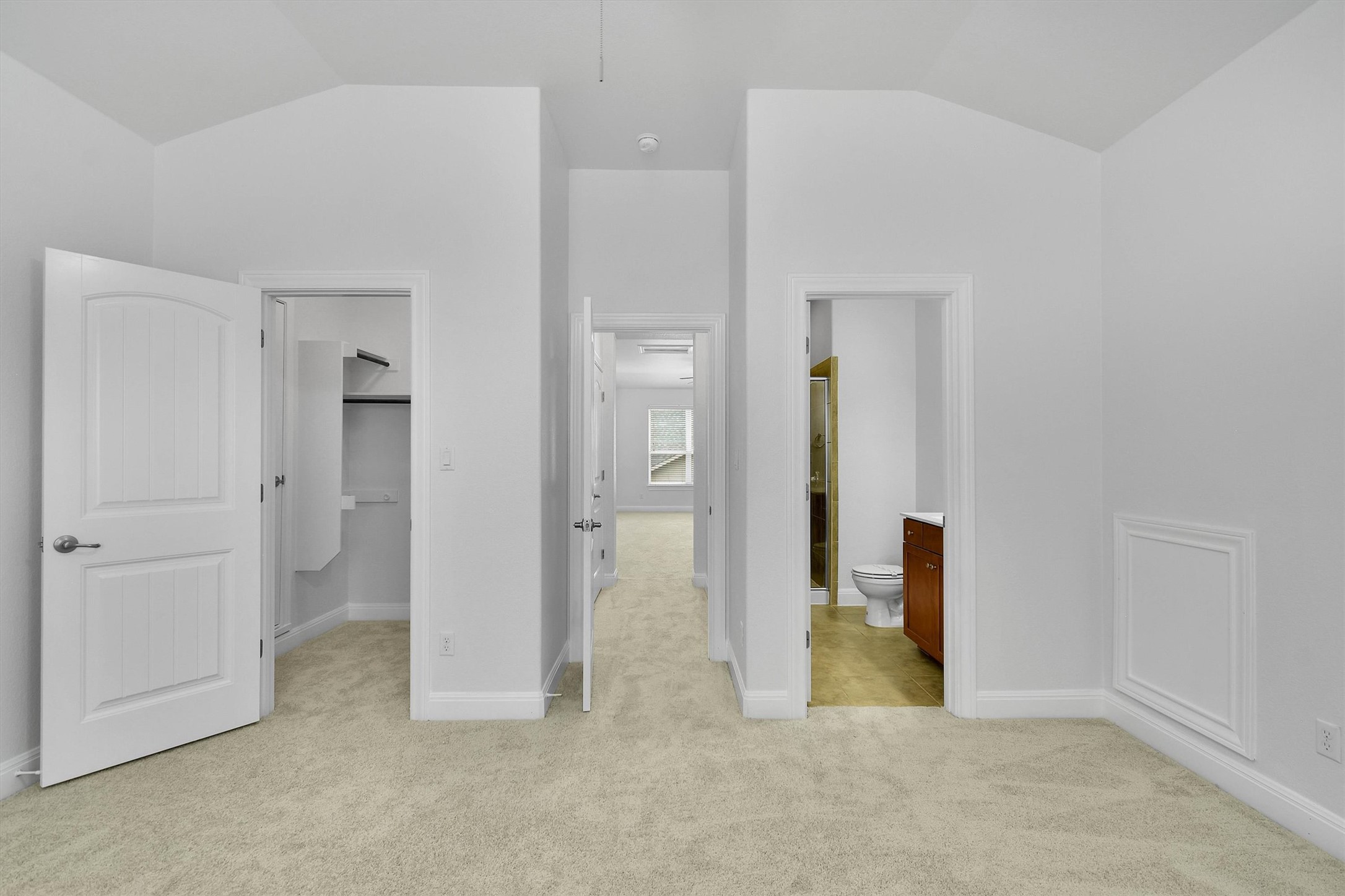 2325 Blended Tree Ranch Drive Leander, TX 78641 - Photo 31 of 35 Step into a generously sized bedroom with plush carpeting, offering convenient access to both a walk-in closet and an en-suite bathroom.
