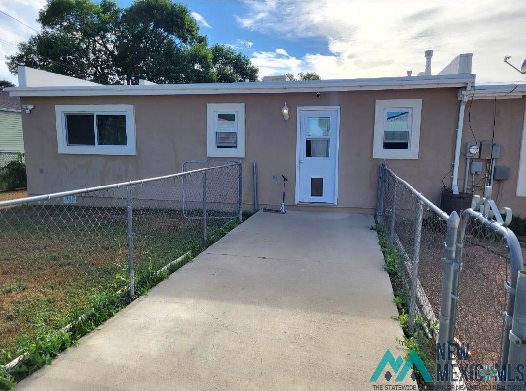 1375 Brilliant Street Raton, NM 87740 - Photo 18 of 19 Bungalow featuring stucco siding and a patio. Fenced yard. Storage shed. Concrete sidewalk.
