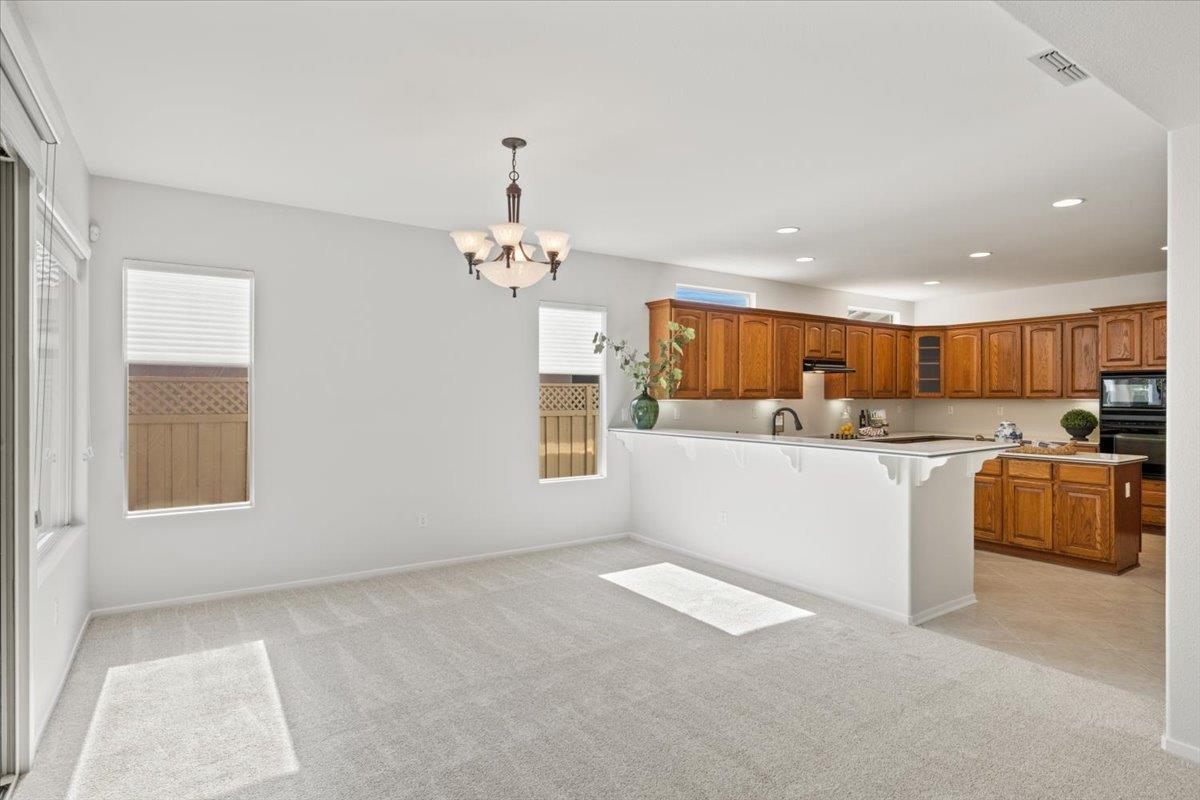 851 Rocky Ridge Lane Lincoln, CA 95648 - Photo 8 of 31 a view of open kitchen with kitchen island and stainless steel appliances