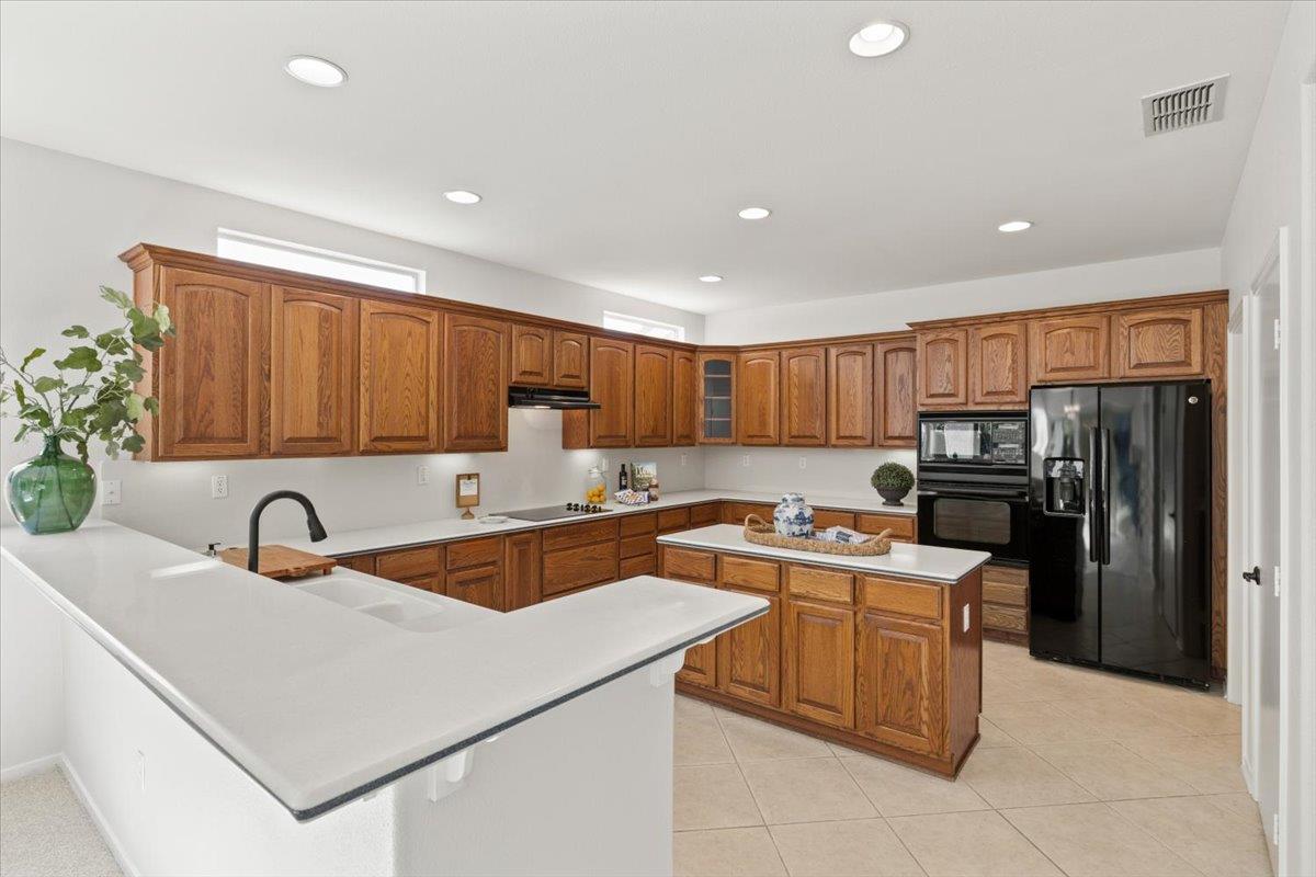 851 Rocky Ridge Lane Lincoln, CA 95648 - Photo 10 of 31 a kitchen with a sink a stove and refrigerator