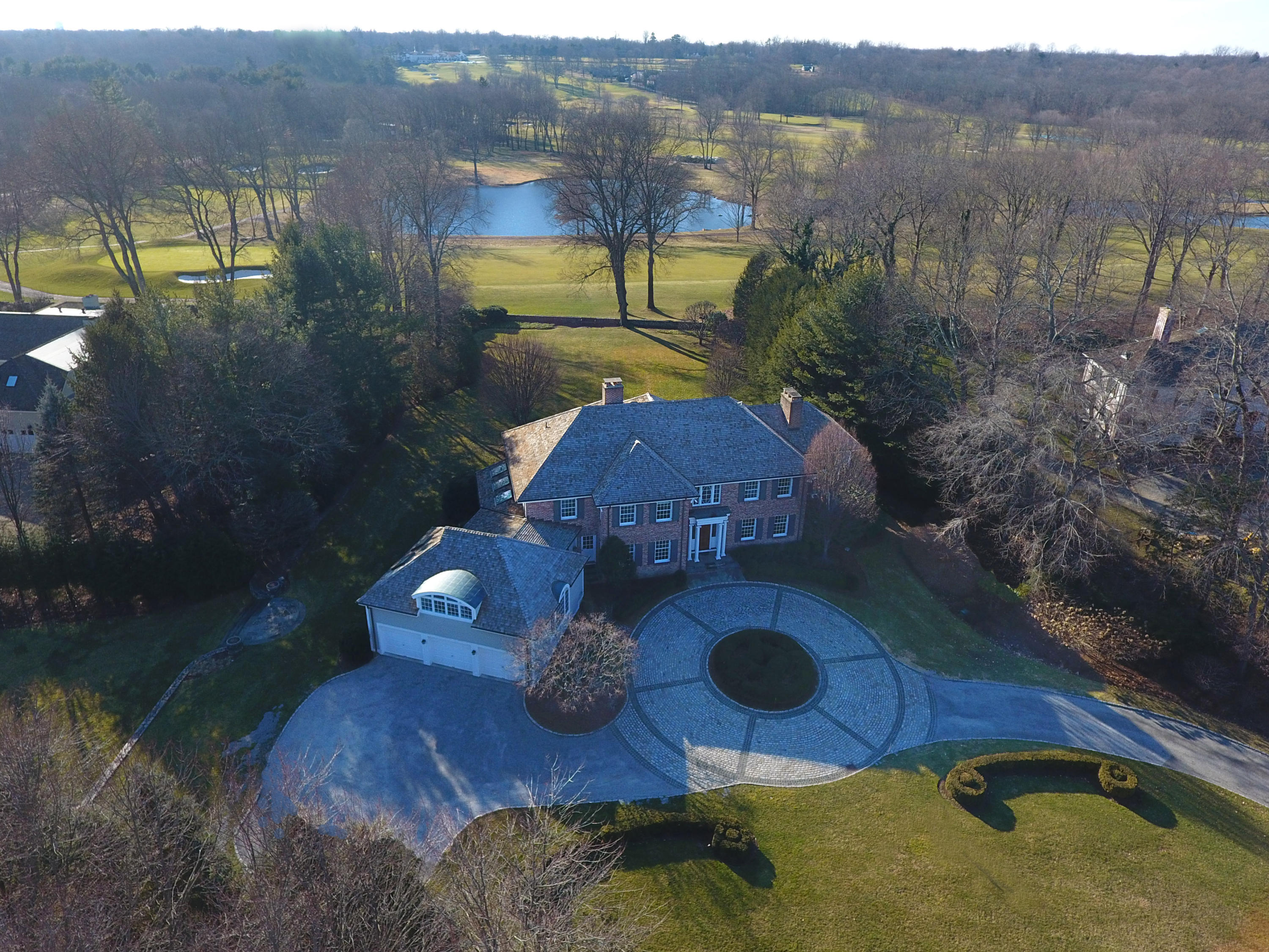 a aerial view of a house with backyard swimming pool and outdoor seating