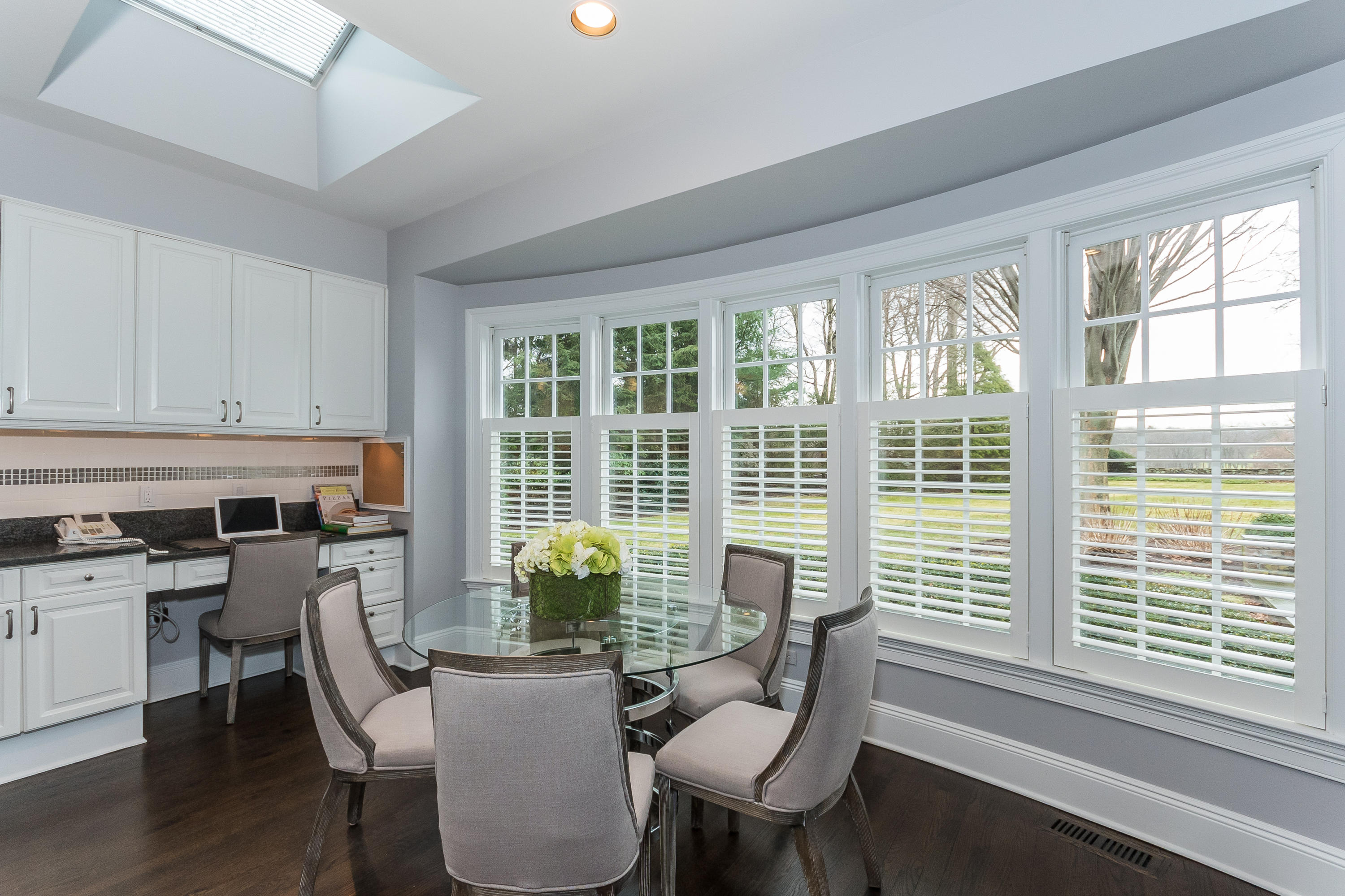 459 Middlesex Road Darien, CT 06820 - Photo 14 of 53 a dining room with furniture window wooden floor and plants