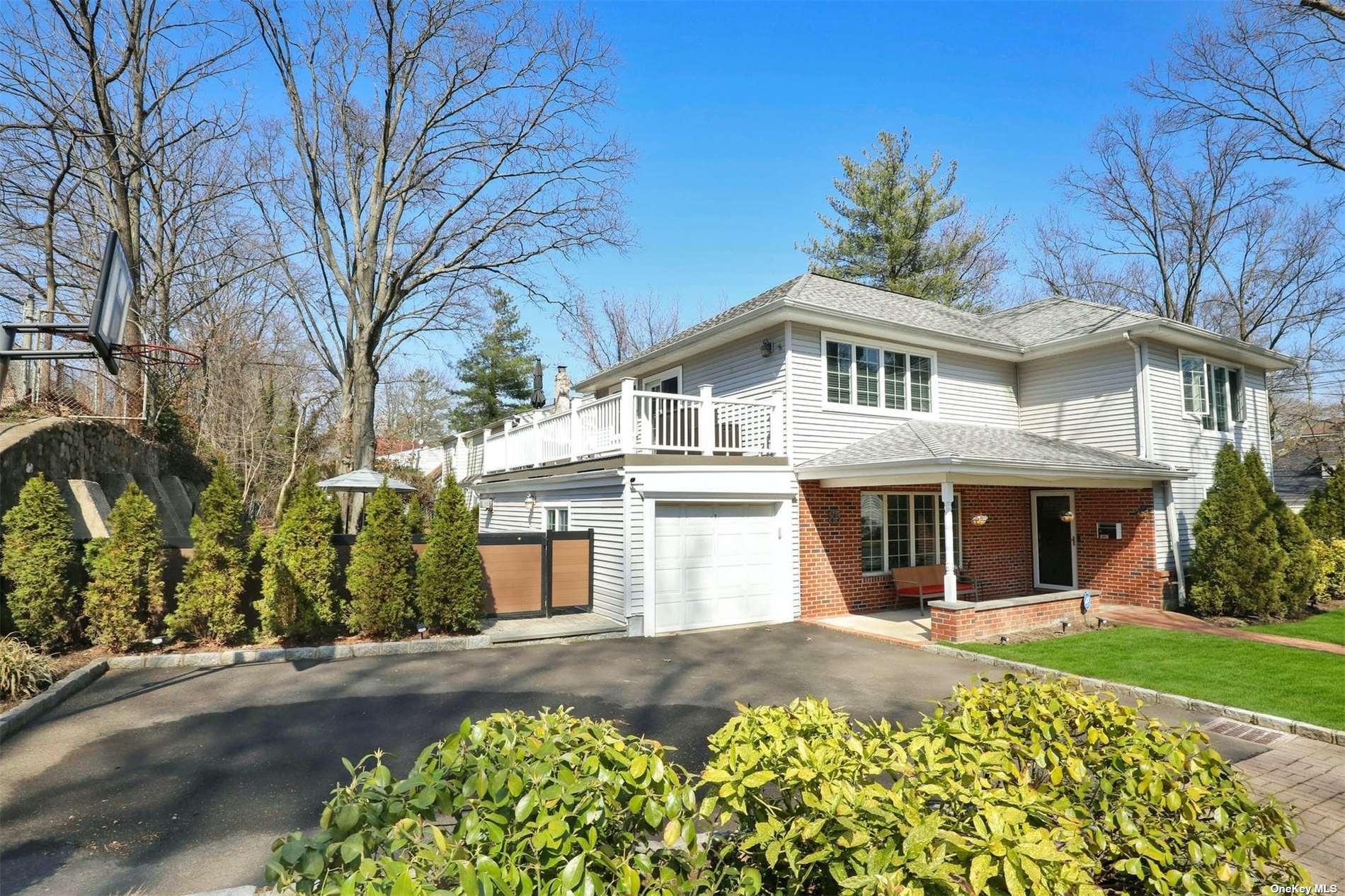 85 Baker Hill Road Great Neck, NY 11023 - Photo 1 of 1 front view of a house with a yard