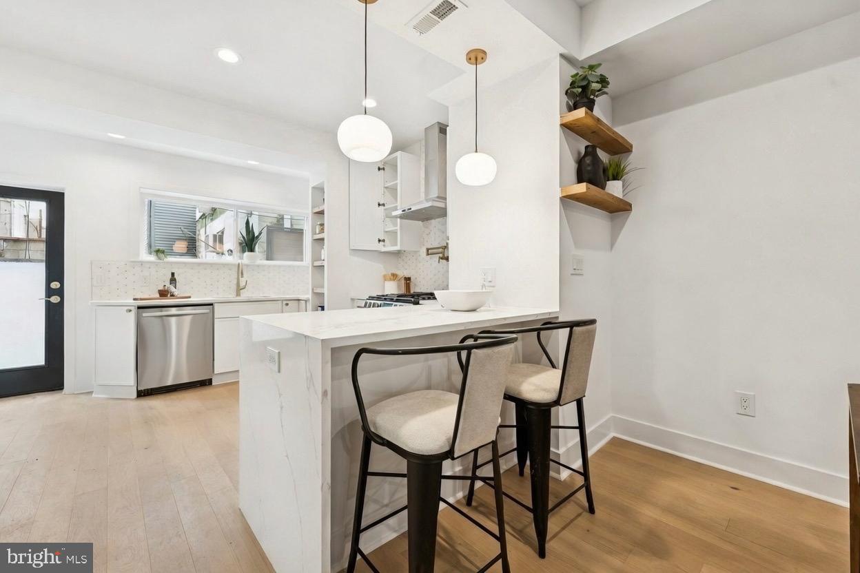 1019 Ellsworth Street Philadelphia, PA 19147 - Photo 13 of 31 a kitchen with a table and chairs in it