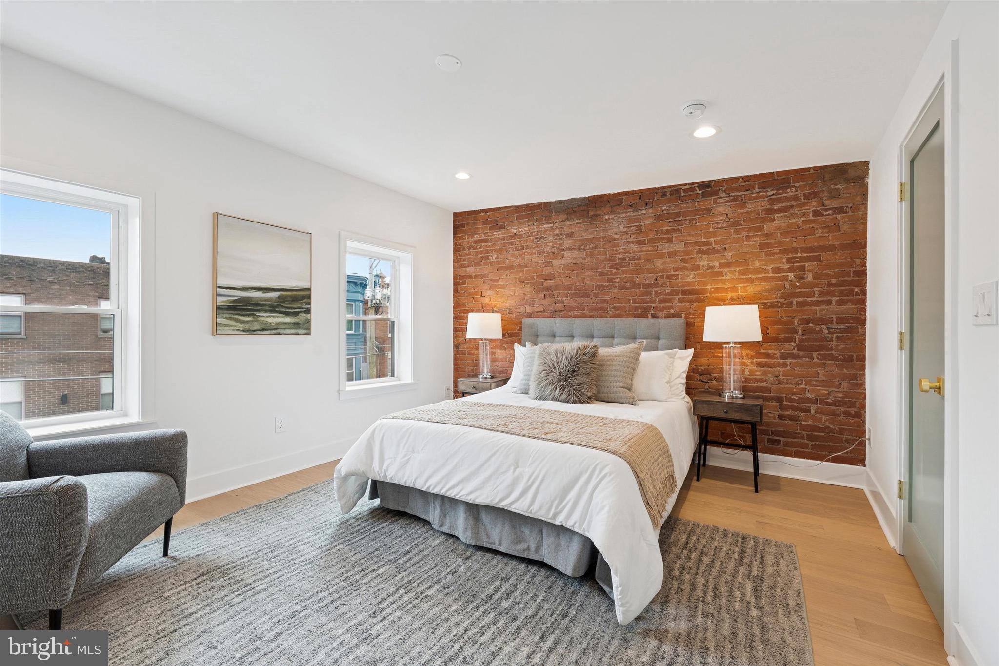1019 Ellsworth Street Philadelphia, PA 19147 - Photo 15 of 31 a bedroom with a large bed couch and a window
