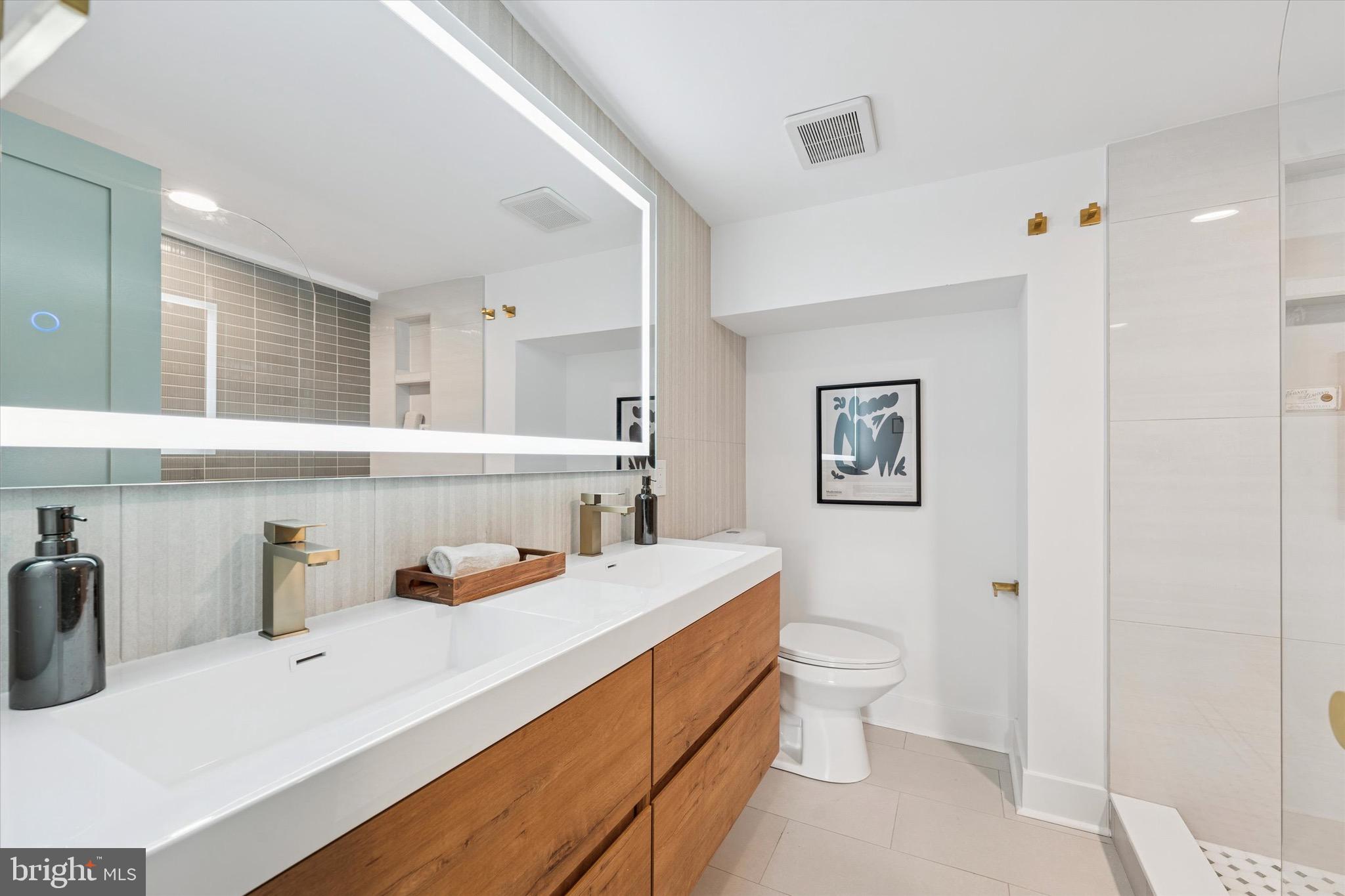 1019 Ellsworth Street Philadelphia, PA 19147 - Photo 20 of 31 a bathroom with a sink toilet vanity and tub