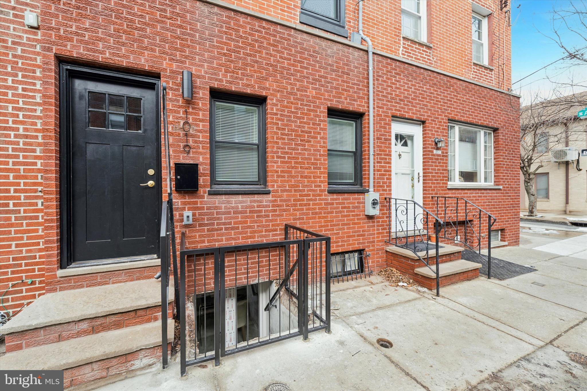 1019 Ellsworth Street Philadelphia, PA 19147 - Photo 30 of 31 a view of a brick house with a bench in the patio
