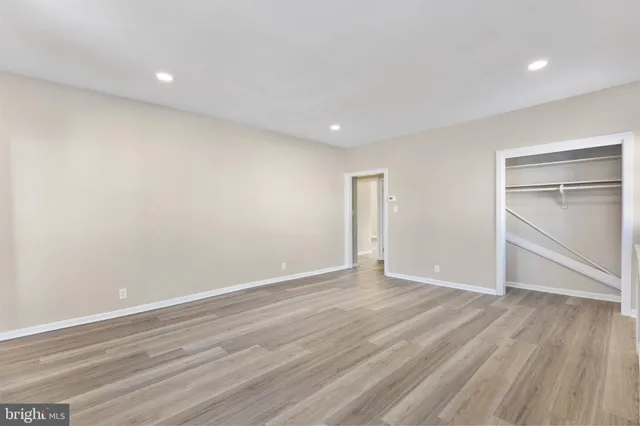 a view of an empty room with wooden floor