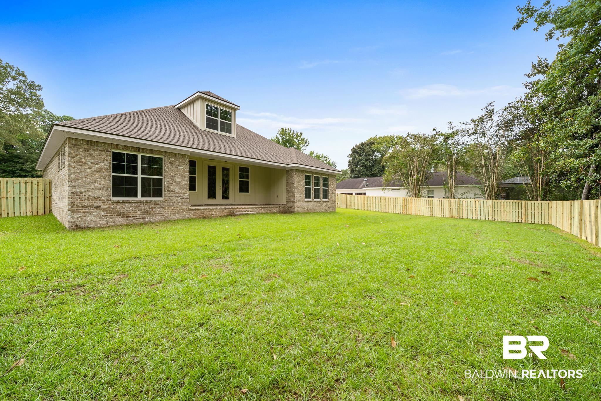29 Signal Hill Road Daphne, AL 36527 - Photo 30 of 36 Rear view of property featuring a lawn