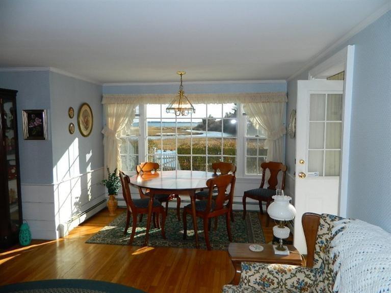 11 Harbor Bluff Road Hyannis, MA 02601 - Photo 11 of 30 a view of a dining room with furniture wooden floor and chandelier