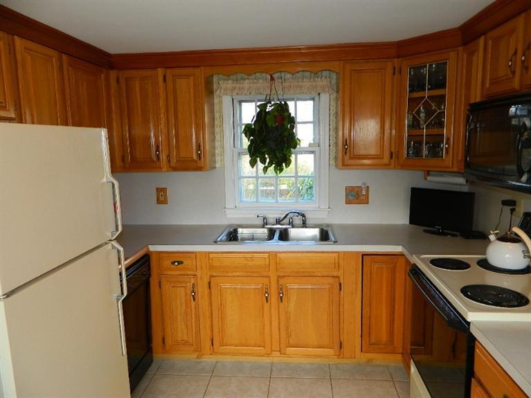 11 Harbor Bluff Road Hyannis, MA 02601 - Photo 17 of 30 a kitchen with a sink a stove and a refrigerator