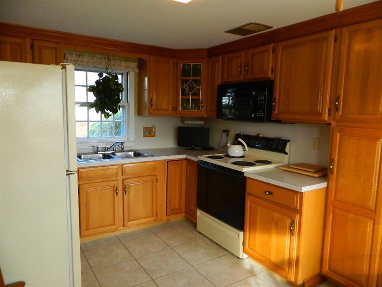 11 Harbor Bluff Road Hyannis, MA 02601 - Photo 18 of 30 a kitchen with stainless steel appliances granite countertop a sink stove and microwave