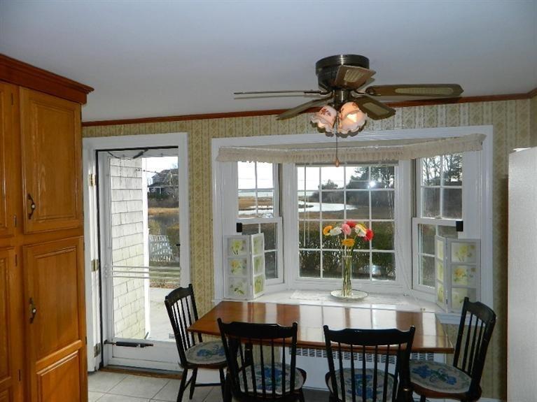 11 Harbor Bluff Road Hyannis, MA 02601 - Photo 19 of 30 a dining room with wooden floor a chandelier