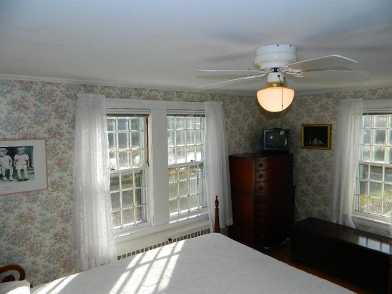 11 Harbor Bluff Road Hyannis, MA 02601 - Photo 22 of 30 a bedroom with a bed and window