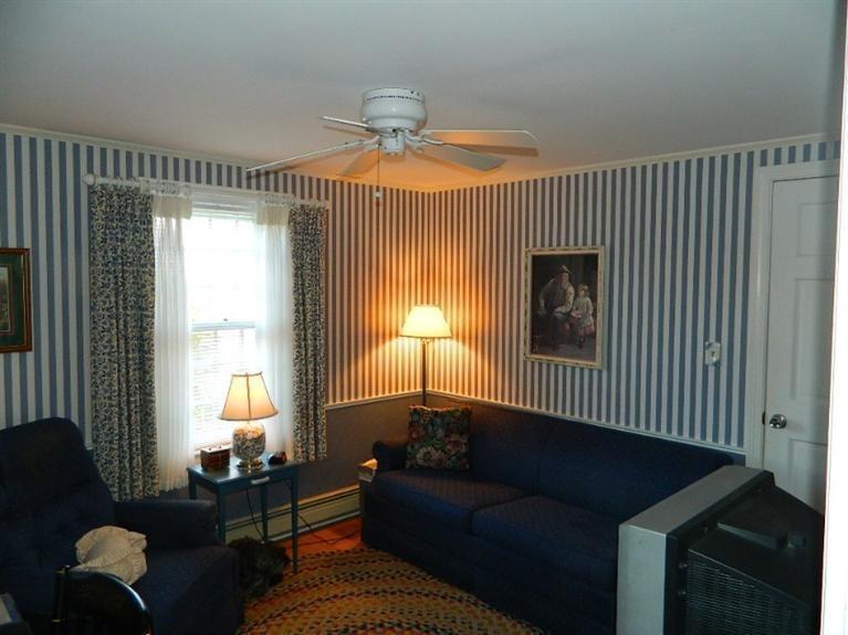 11 Harbor Bluff Road Hyannis, MA 02601 - Photo 26 of 30 a living room with furniture and a chandelier