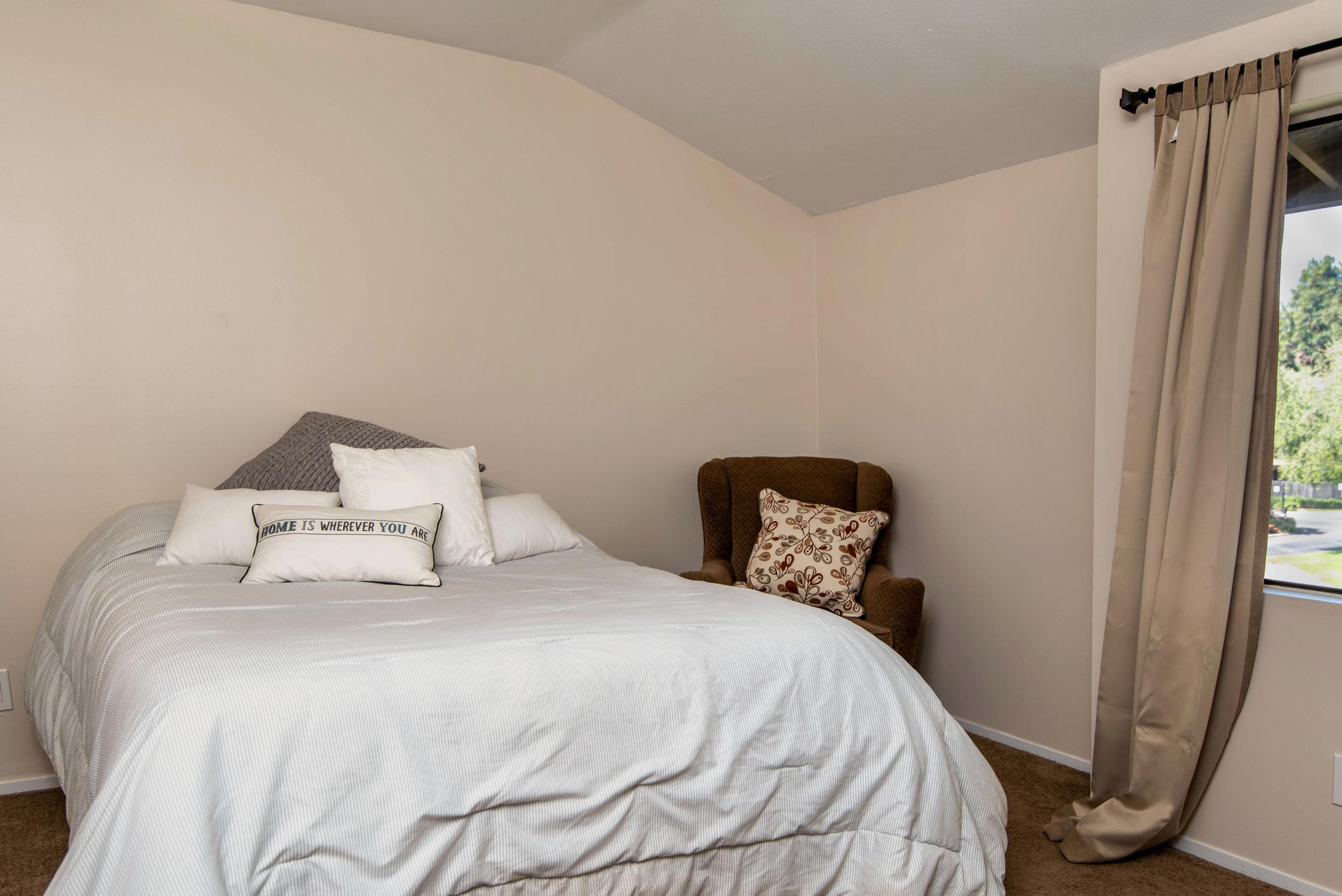 202 North R Street Lompoc, CA 93436 - Photo 11 of 12 a bedroom with a bed and a large mirror