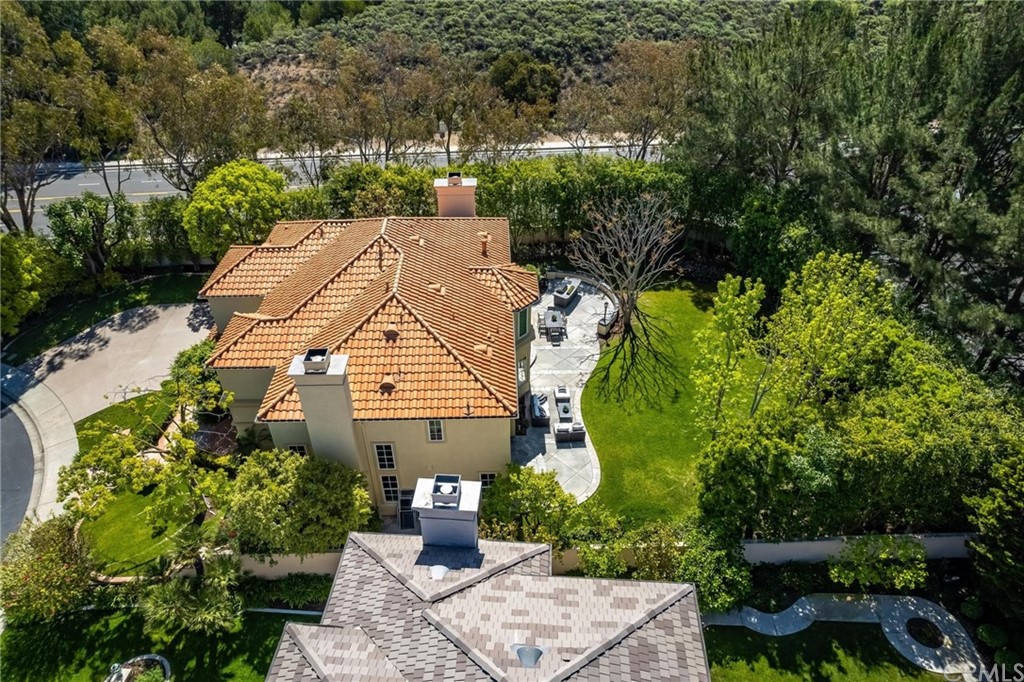 22 Meryton Irvine, CA 92603 - Photo 34 of 37 a view of a patio with table and chairs potted plants and large tree