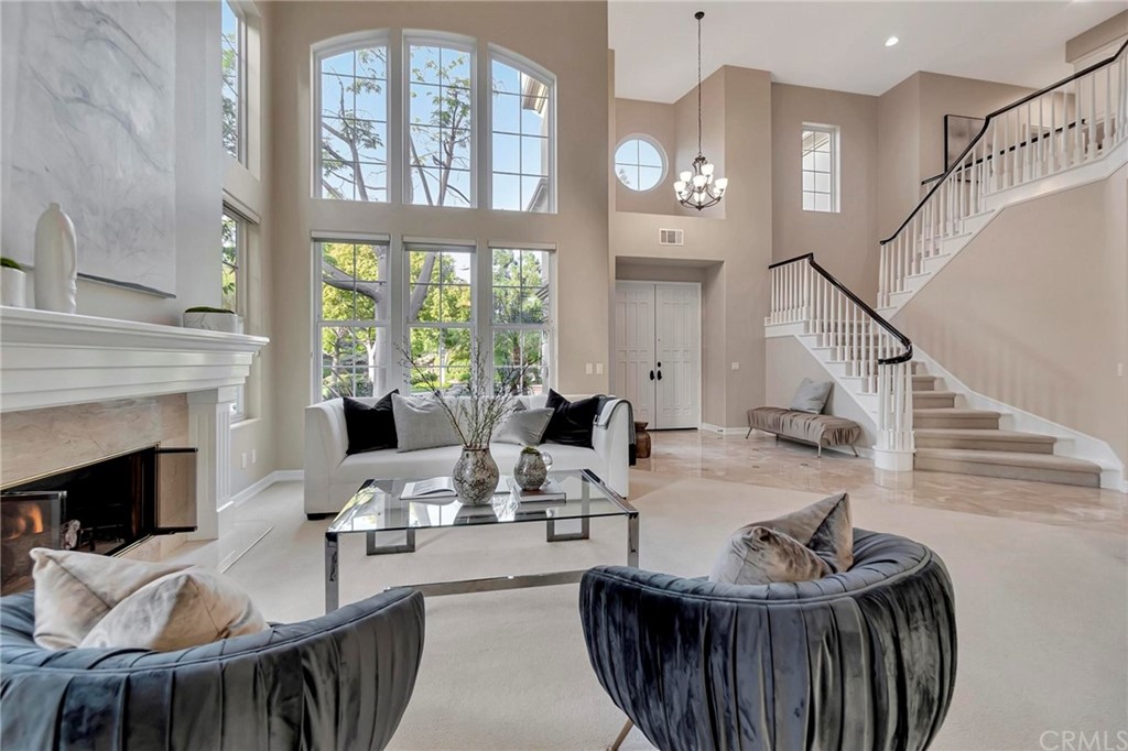 22 Meryton Irvine, CA 92603 - Photo 6 of 37 a living room with furniture a fireplace and a large window