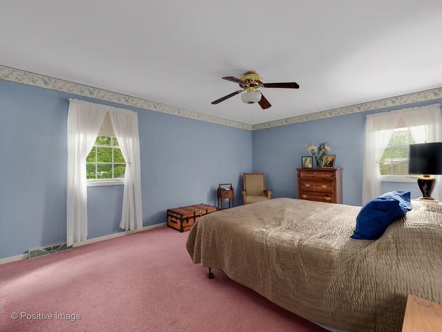 28W241 Garys Mill Road Winfield, IL 60190 - Photo 22 of 34 a bedroom with a bed and a chandelier