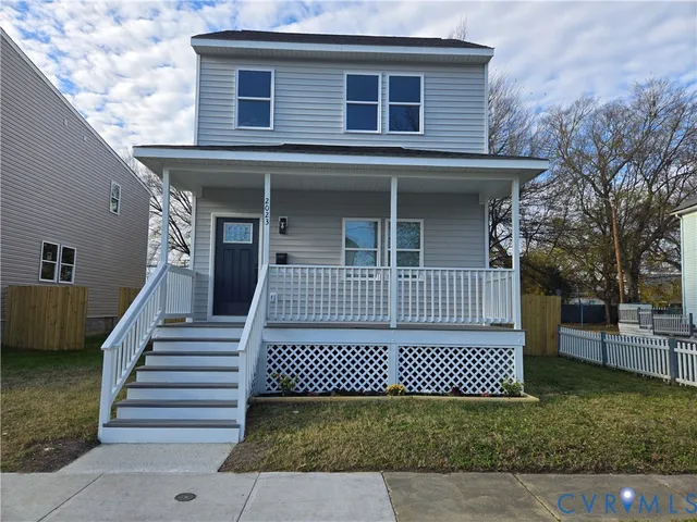 a view of a house with wooden door and furniture