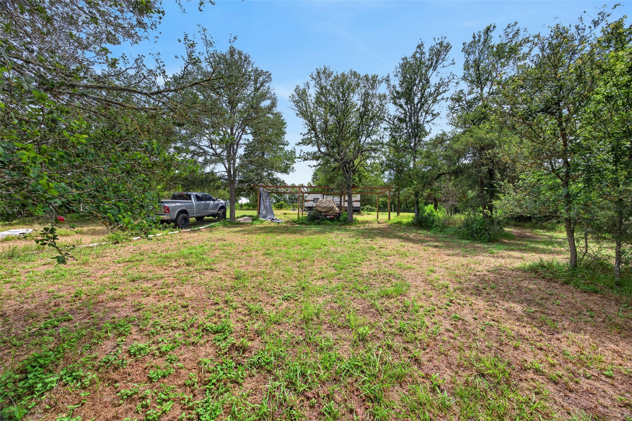 266 Beaver Road Elgin, TX 78621 - Photo 23 of 40 A spacious, tree-lined lot offering ample room for potential development.